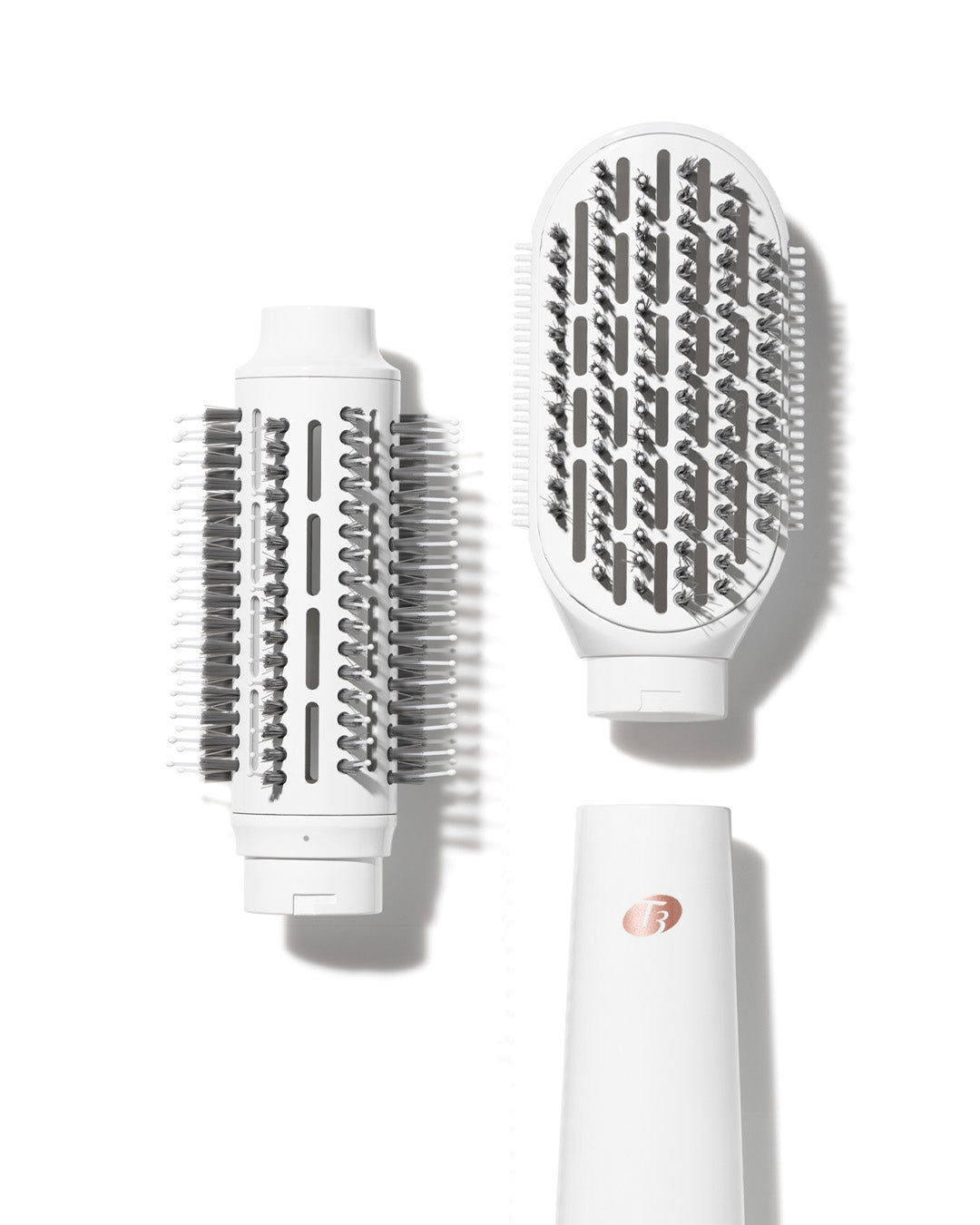 T3 AireBrush Duo hot air styling tool disassembled, showing the white handle, round brush head, and paddle brush head.