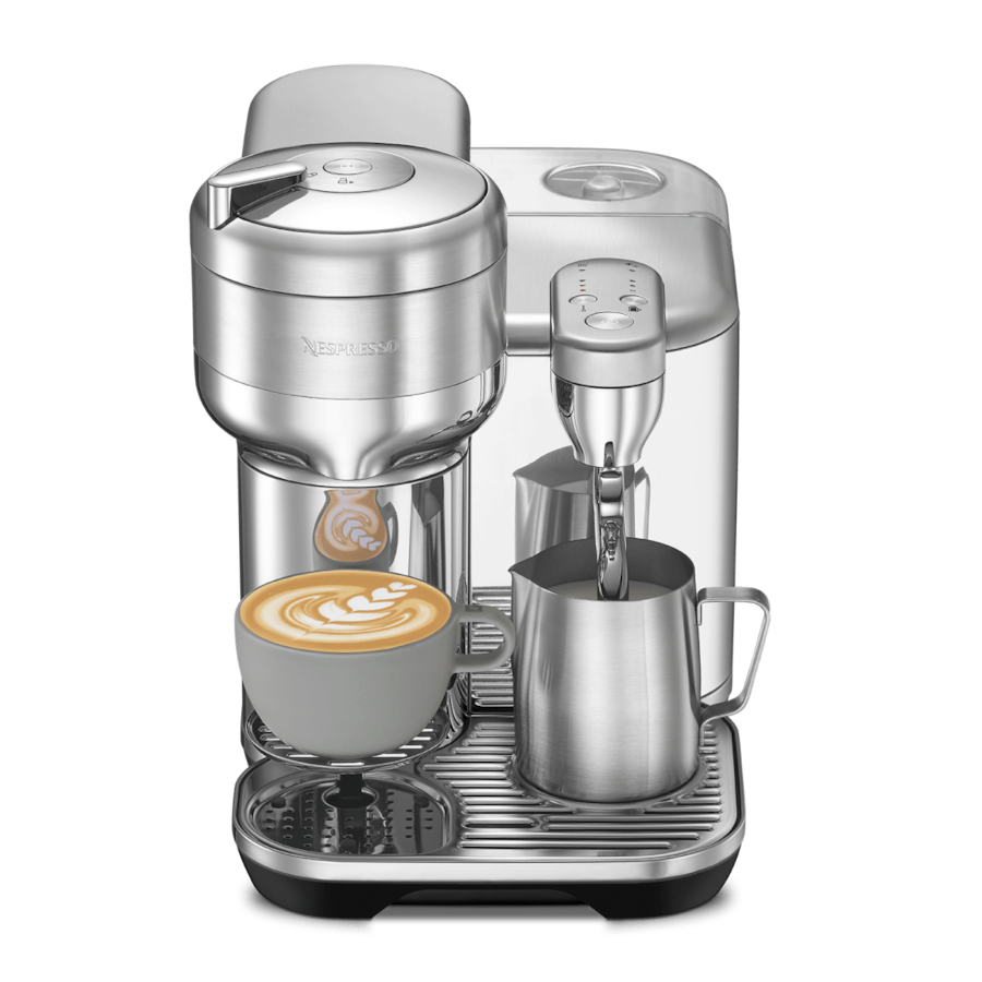 Sleek silver Nespresso Vertuo Creatista coffee machine making latte art coffee with milk frother and pitcher.