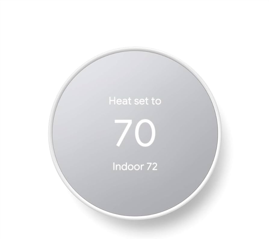 A white Google Nest Thermostat displaying 'Heat set to 70' as the setpoint and 'Indoor 72' as the current room temperature.