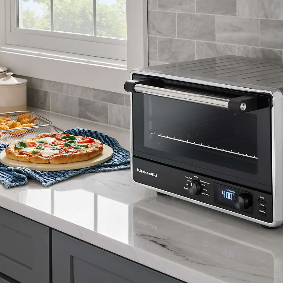 KitchenAid K450 Smart Countertop Oven with pizza, fried food on marble counter. Display shows 400 degrees.