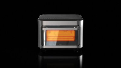 Brava Glass Smart Oven with stainless steel finish and glowing interior on a black reflective surface.