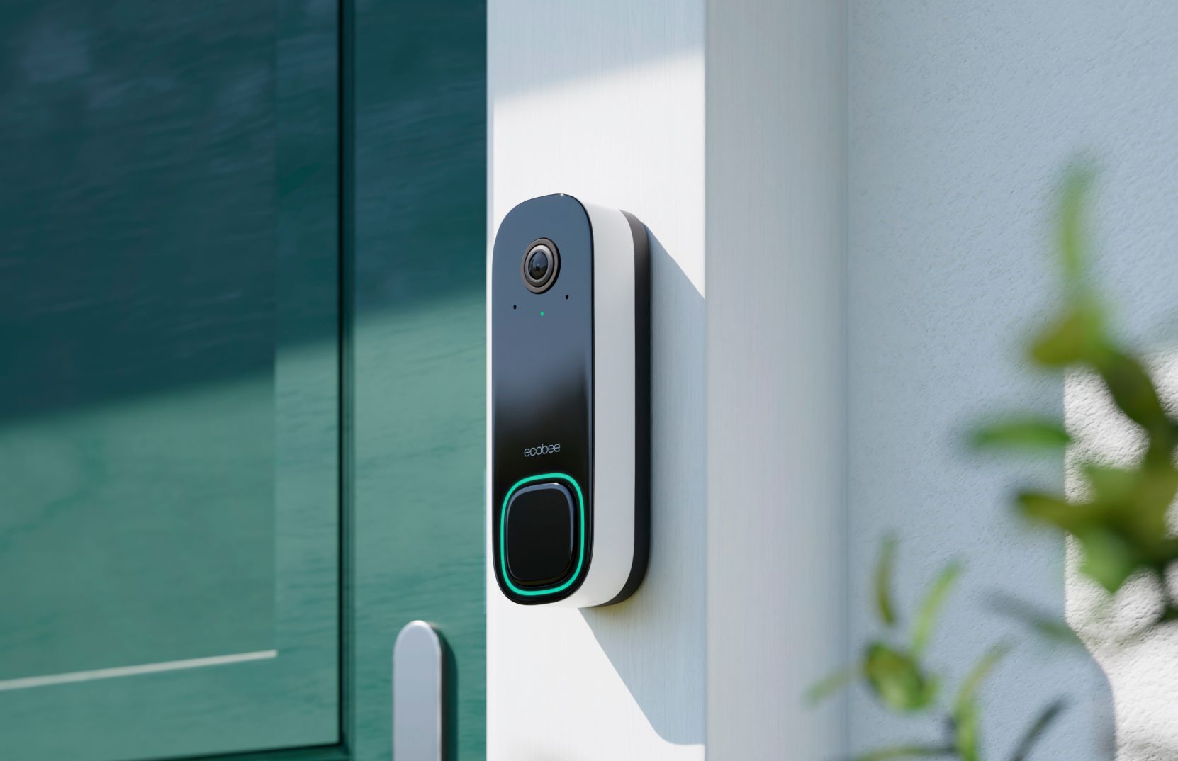 Ecobee Smart Video Doorbell mounted on a white wall next to a teal door, with a green illuminated button.