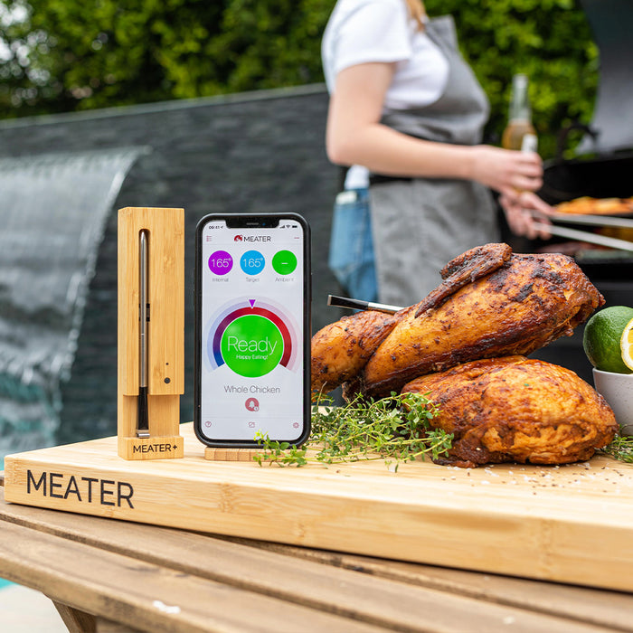 Meater Plus smart thermometer & app displaying 'Ready' for perfectly grilled whole chickens on a wooden board.
